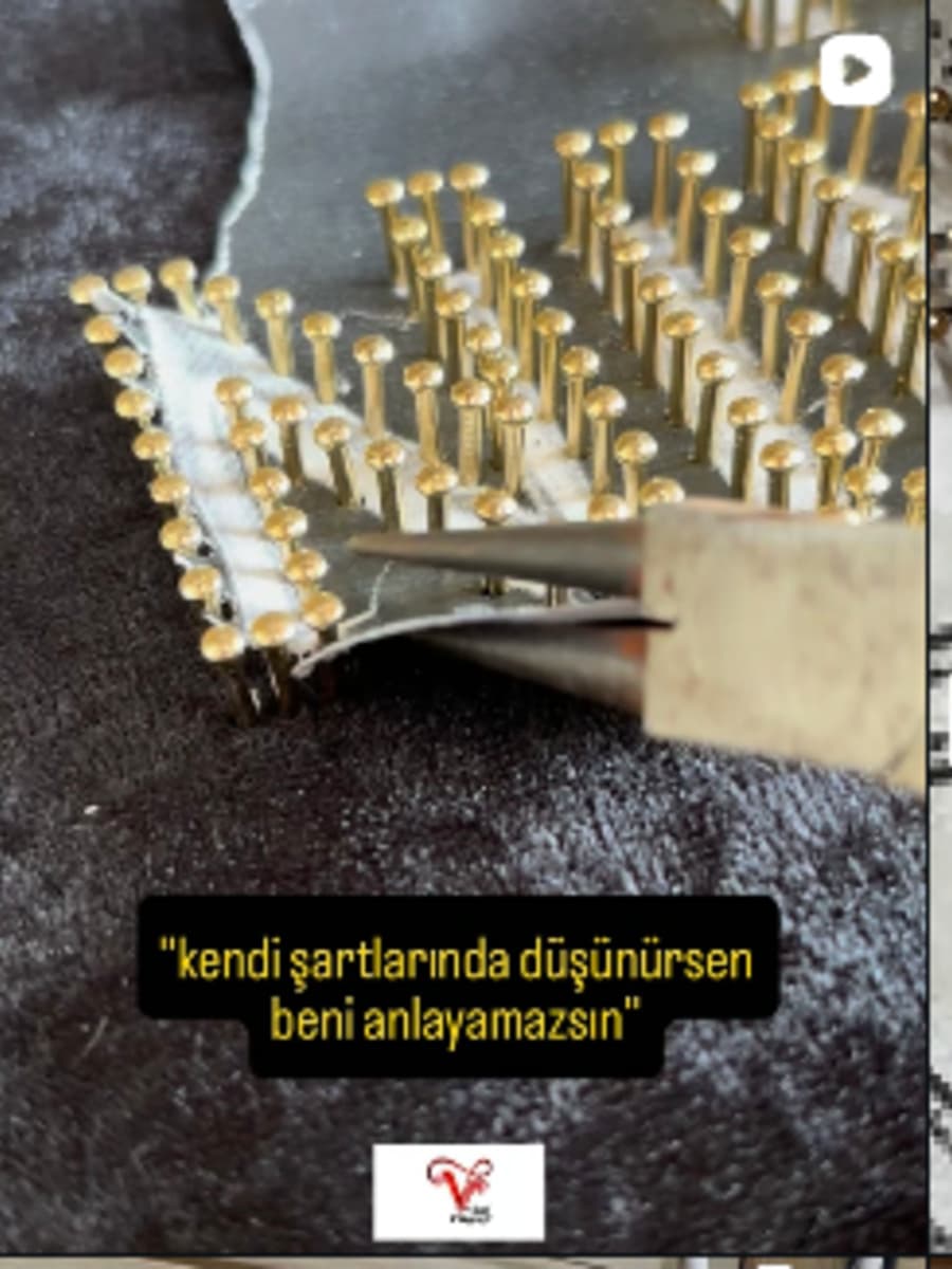 Koyu zemin üzerinde altın renkli tellerle yapılmış string art eseri
